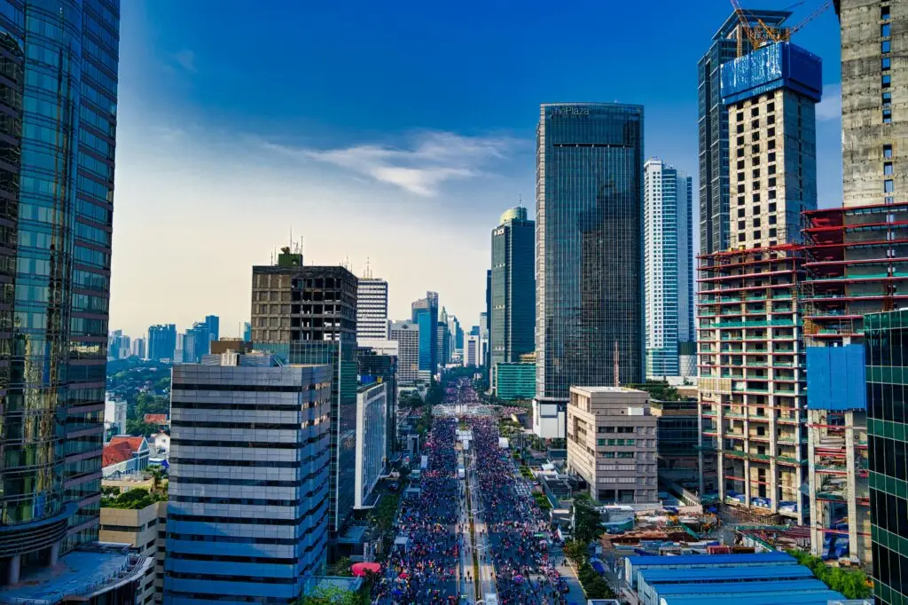 Stunning aerial view of Jakarta's modern skyline with bustling streets below. Who we serve.
