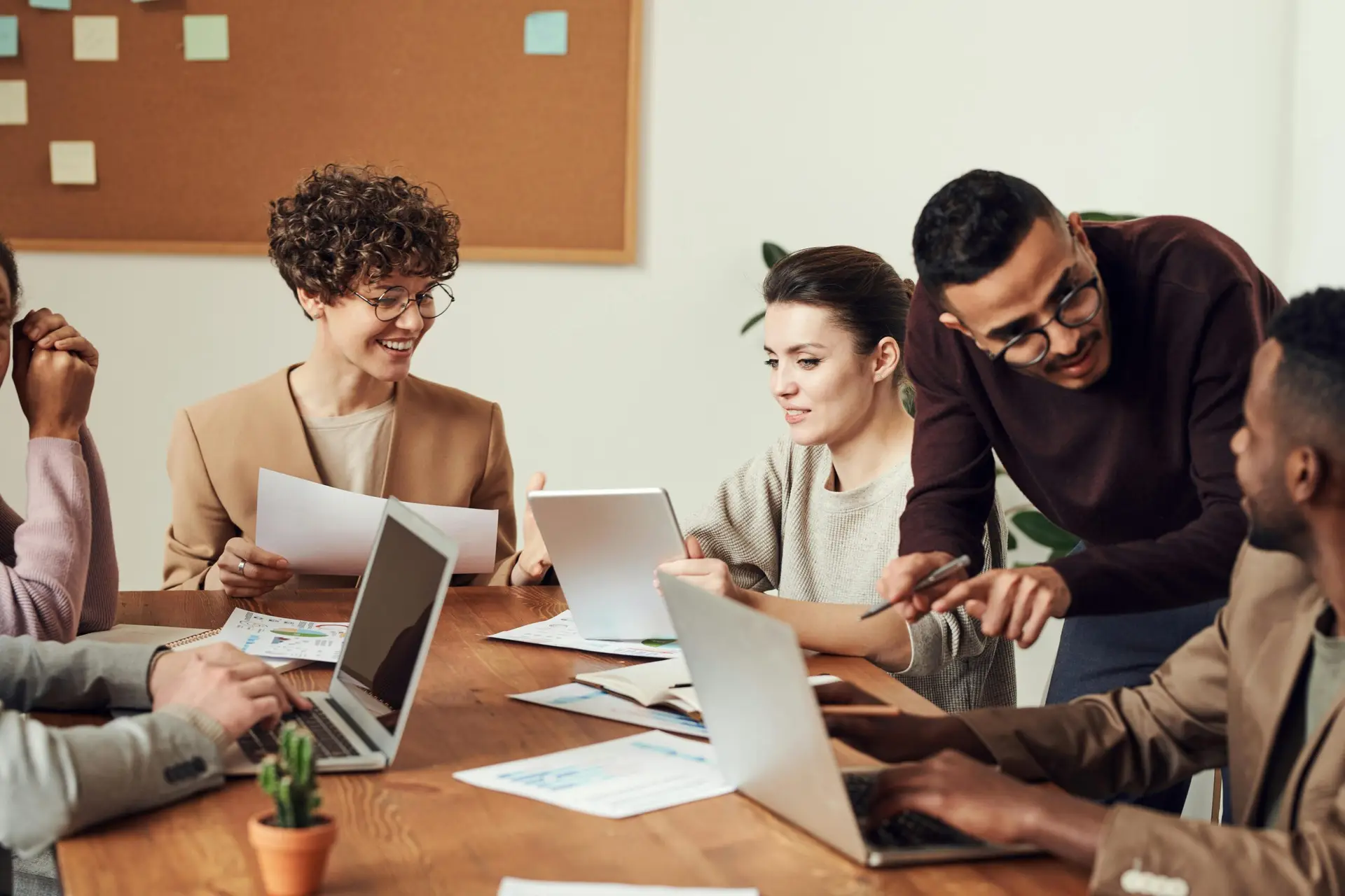 A diverse group of professionals engaged in a collaborative office meeting.